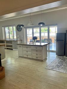 a kitchen with a large island in the middle at The Townhouse in Piet Retief +12 photos