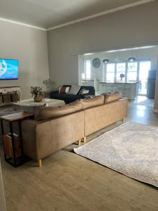 un soggiorno con un grande divano in una camera di The Townhouse Mkhondo a Piet Retief
