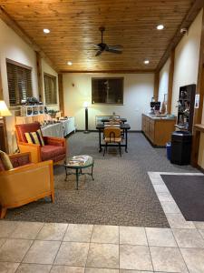 a living room with couches and tables and a ceiling at The Rushford Inn in Rushford