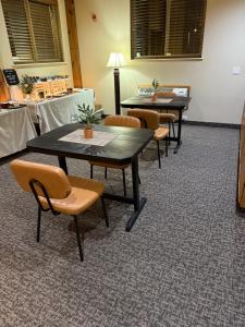 a group of tables and chairs in a room at The Rushford Inn in Rushford