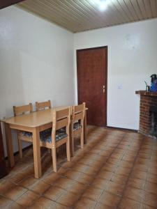 a dining room with a wooden table and chairs at Casa Hermosa in São Gabriel