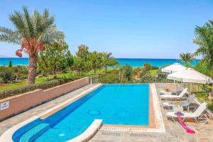 a swimming pool with a view of the ocean at Villa Galene in Polis Chrysochous