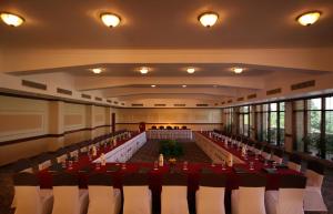 a banquet hall with a long table and chairs at Clarks Khajuraho in Khajurāho +47 photos