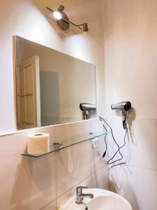 a bathroom with a mirror and a sink at Illa B&B in Cusco +120 photos