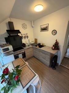 une cuisine avec une table et une cuisine avec un arbre de Noël dans l'établissement Charmant T1 au calme, à Cernay