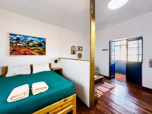 a bedroom with a bed with two towels on it at Illa B&B in Cusco