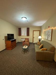 a living room with a couch and a tv at The Rushford Inn in Rushford