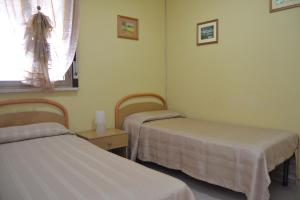A bed or beds in a room at Casa Vacanze Laura