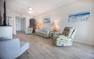 a living room with a couch and a chair at Phoenix East 1108 in Orange Beach +38 photos