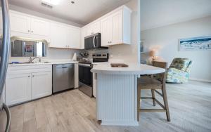 a kitchen with white cabinets and a white counter top at Phoenix East 1108 in Orange Beach