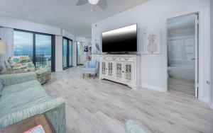 a living room with a flat screen tv and a couch at Phoenix East 1108 in Orange Beach