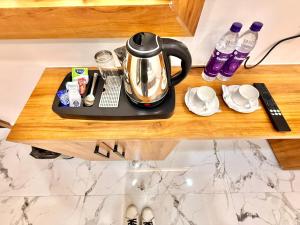 a tea kettle on a tray on a shelf at Hotel Betwa sarowar in Orchha