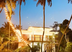 a white house with palm trees in front of it at Danketiya Palace in Ahangama