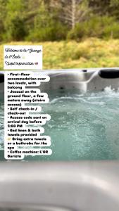 a sign on the side of a window with water at Grange de l'ancienne école avec Jacuzzi privé in Gérardmer