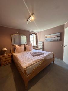 a bedroom with a large bed with a large mirror at Helle Souterrain-Wohnung mit eigenem Eingang in Erftstadt