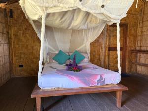 a bed with a canopy in a room at Fireworks bungalows in White Sands