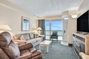 a living room with a couch and a television at Daytona Beach Resort 532-White Turtle in Daytona Beach