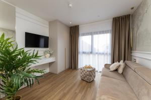 a living room with a couch and a tv at Sunday Residence Split in Split