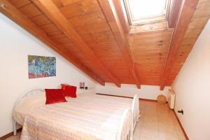 a bedroom with a bed and a wooden ceiling at Urban Oasis in Cormano +24 photos