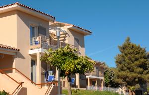 a building with balconies and trees in front of it at Résidence Odalys Les Océanides in La Londe-les-Maures