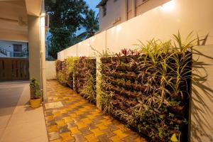 a fence with plants on the side of a building at Aura Heaven in Thanjāvūr
