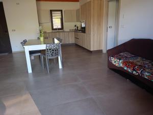 a living room with a table and a couch at villa VM in Maniace