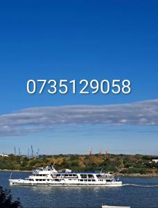 a white boat in the water on a lake at Danubius view apartment in Tulcea