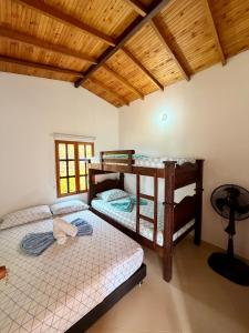 En eller flere senge i et værelse på Cabañas San Miguel Arcángel