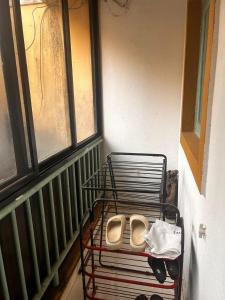 a pair of shoes sitting on a shelf next to a window at Palms Cosy affordable homely flat in Arpora