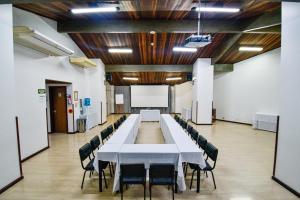 a large conference room with a long table and chairs at Hotel Jaragua in Joaçaba +57 photos