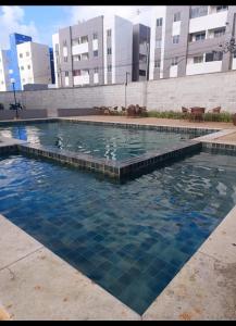a swimming pool in the middle of a building at Cantinho do Sossego in João Pessoa +4 photos