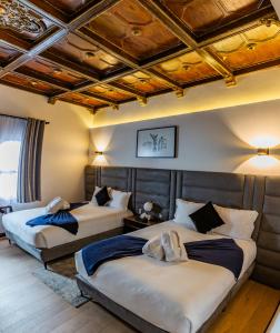 two beds in a room with wooden ceilings at Casa Castillo in Mexico City