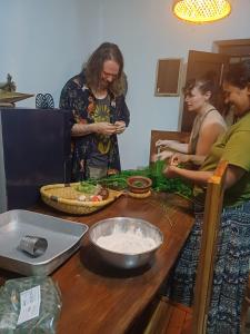 a group of people standing around a table preparing food at Malabar home stay by Jaffna Tours & Excursions in Jaffna