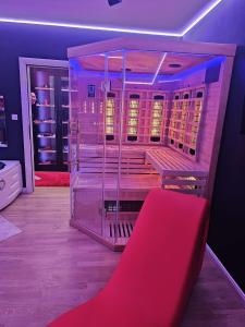 a red bench in a room with a closet at Apartman Fantazy spa BDSM in Novi Grad
