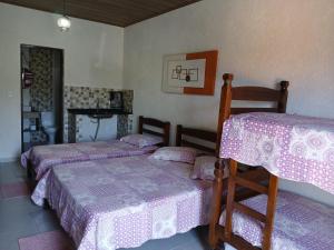 En eller flere senge i et værelse på Pousada Recanto Solarium + 8 billeder