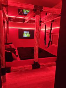a room with red lights on a bunk bed at Apartman Fantazy spa BDSM in Novi Grad +23 photos