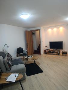 a living room with a couch and a flat screen tv at Hamedina de Silvina in Kafr Sābā