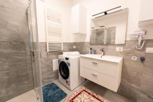 a bathroom with a washing machine and a sink at B&B Maison Sophie SOVERATO MARINA in Soverato Marina +36 photos
