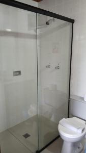 a bathroom with a glass shower and a toilet at HOTEL CAMPO ALEGRE in Campo Alegre
