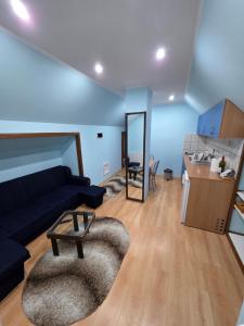 a living room with a couch and a table at D&D Apartment in Koceljevo