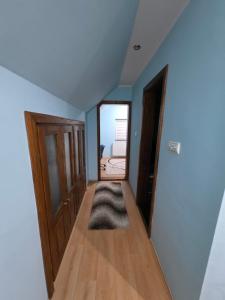 a room with a hallway with a door and a rug at D&D Apartment in Koceljevo +7 photos