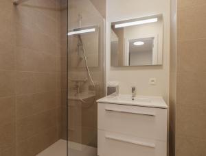 a bathroom with a shower and a sink and a mirror at X-Corner Ostend - Casselbergh Residences in Ostend +9 photos