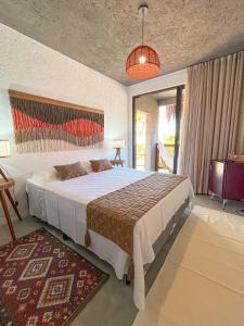 ein Schlafzimmer mit einem großen Bett in einem Zimmer in der Unterkunft Zami 03 & 04 in Pôrto de Pedras