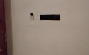 a television on a wall in a room at Green cottage Ella in Ella