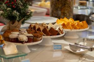 a table with three plates of muffins and chips at Hotel Portinari Centro in Foz do Iguaçu