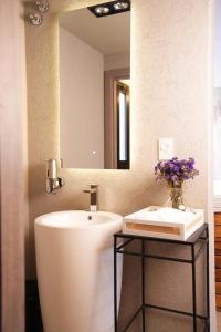 a bathroom with a sink and a mirror at Aira Apart Hotel Boutique in Buenos Aires