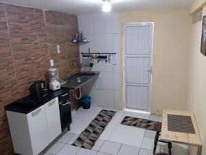 a small kitchen with a sink and a counter at kit Net B in São Luís