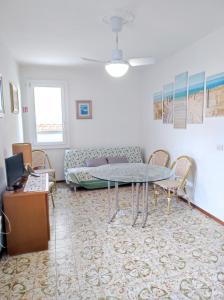 a living room with a couch and a table at Appartamento Cervia in Cervia
