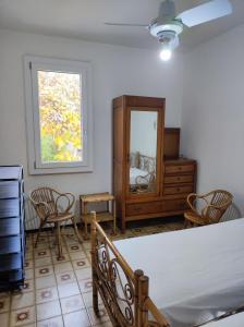 a bedroom with a bed and a dresser and a mirror at Appartamento Cervia in Cervia