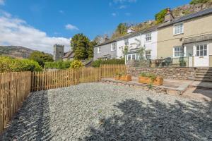 a backyard with a wooden fence and a house at 2 Bed in Chapel Stile oc-u32104 in Chapel Stile